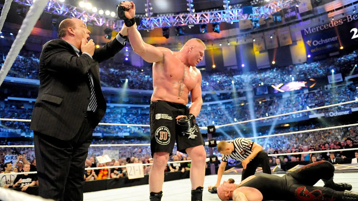 Paul Heyman Raises Brock Lesnars Hand Over The Undertaker